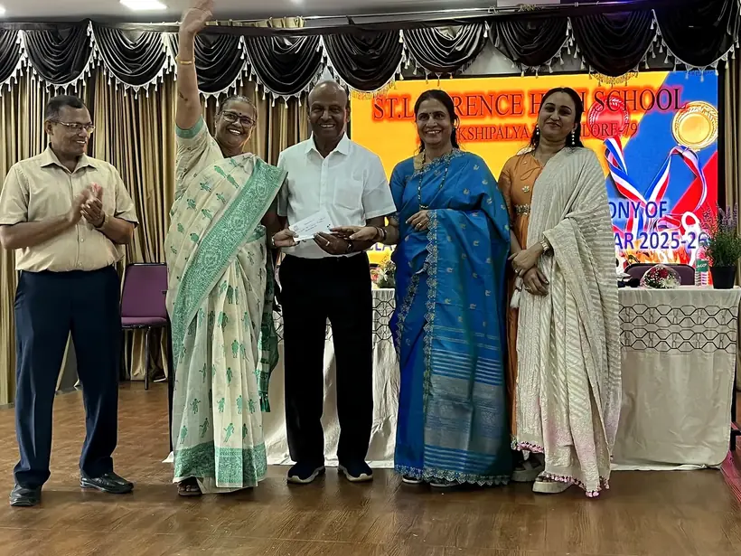 School management presenting an award to a student at the felicitation ceremony