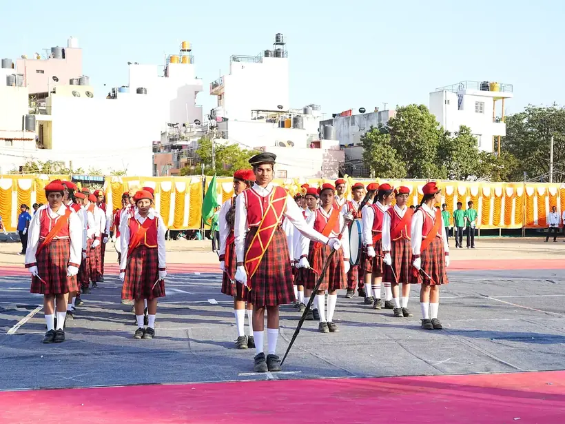 Students in uniform marching in formation on the school ground during the march past