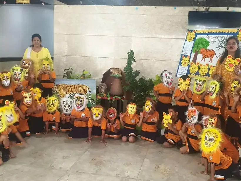 Kindergarten children in themed costumes and masks in a decorated classroom