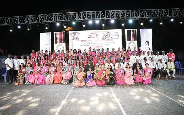 School staff gathered on stage during a school event