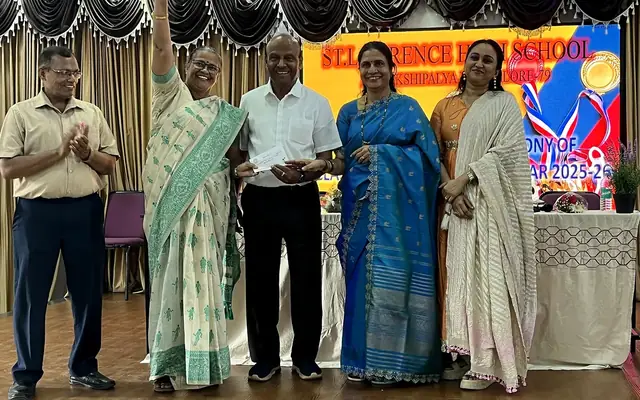 School management presenting an award to a student at the felicitation ceremony