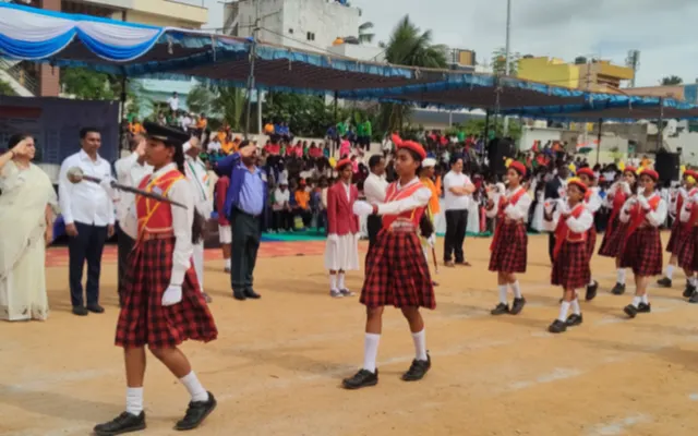 Primary school girls in tartan skirts marching past the saluting dais during the Independence Day parade