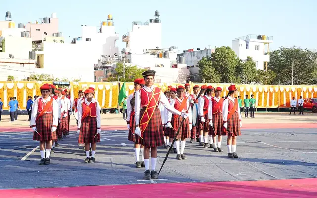 Students in uniform marching in formation on the school ground during the march past