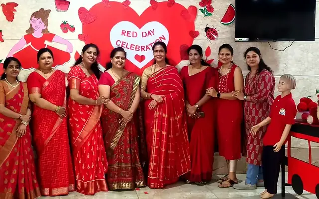 Teachers dressed in red sarees for the school Red Day colour concept celebration