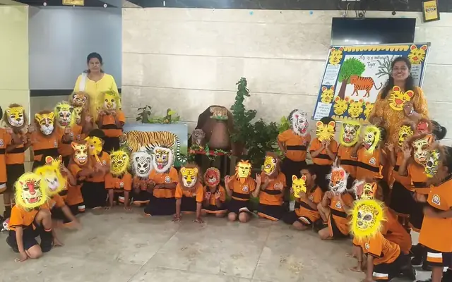 Kindergarten children in themed costumes and masks in a decorated classroom